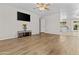 Open living room with wood-look flooring, a ceiling fan, and great natural light at 2435 E Harmony Ave, Mesa, AZ 85204