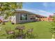 Expansive backyard featuring a well-manicured lawn and outdoor dining area at 26032 W Quail Ave, Buckeye, AZ 85396