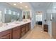 Bright bathroom with a large mirror, double sinks, and a glass enclosed shower at 26032 W Quail Ave, Buckeye, AZ 85396