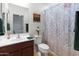 Well-lit bathroom with a sink, toilet, shower-tub combination and decorative towels at 26032 W Quail Ave, Buckeye, AZ 85396