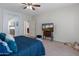 Comfortable bedroom with a TV and a view to a connected bathroom at 26032 W Quail Ave, Buckeye, AZ 85396