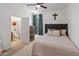 Comfortable bedroom with a decorative cross, neutral tones, and plenty of natural light at 26032 W Quail Ave, Buckeye, AZ 85396