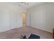 Bedroom featuring a large window and space for exercise equipment at 26032 W Quail Ave, Buckeye, AZ 85396