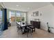 Well-lit dining area with a wooden table and bench seating with views to the back yard at 26032 W Quail Ave, Buckeye, AZ 85396