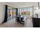 Bright dining room with a large wood table, a bench, chairs, and patio views at 26032 W Quail Ave, Buckeye, AZ 85396