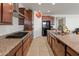 Modern kitchen with stainless steel appliances, granite counters, and ample cabinet space at 26032 W Quail Ave, Buckeye, AZ 85396