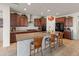 Beautiful kitchen with dark wood cabinets, granite countertops, and a center island at 26032 W Quail Ave, Buckeye, AZ 85396