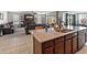 Open kitchen featuring granite counters, stainless sink, and modern faucet in a spacious open-concept design at 26032 W Quail Ave, Buckeye, AZ 85396