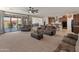 Spacious living room with couches, ceiling fan, and view to the kitchen and outdoor space at 26032 W Quail Ave, Buckeye, AZ 85396