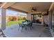 Spacious covered patio with outdoor seating, perfect for entertaining, with a view of the backyard at 26032 W Quail Ave, Buckeye, AZ 85396