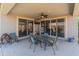 Comfortable covered patio featuring seating, a ceiling fan and lovely backyard views at 26032 W Quail Ave, Buckeye, AZ 85396