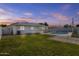 Spacious backyard featuring a sparkling swimming pool, lush lawn, and secure fencing at 2608 W Columbine Dr, Phoenix, AZ 85029