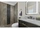 Modern bathroom featuring a tiled shower with mosaic accents and a marble countertop vanity at 2608 W Columbine Dr, Phoenix, AZ 85029