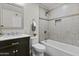 Updated bathroom with marble countertop, tiled shower and bathtub, and decorative mirror at 2608 W Columbine Dr, Phoenix, AZ 85029