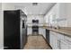 Open concept kitchen with granite countertops, stainless steel appliances, and white cabinetry at 2608 W Columbine Dr, Phoenix, AZ 85029