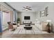 Bright living room with tile flooring, modern furniture, a ceiling fan, and plenty of natural light at 2608 W Columbine Dr, Phoenix, AZ 85029