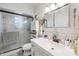 Bright bathroom with a vanity, mirrored cabinet, and glass enclosed shower at 2731 N 23Rd Ave, Phoenix, AZ 85009