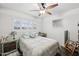 Comfortable bedroom with a ceiling fan, plantation shutters and wood-look floors at 2731 N 23Rd Ave, Phoenix, AZ 85009