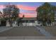 Charming single-story home featuring desert landscaping and a welcoming front porch under a colorful sunset at 2731 N 23Rd Ave, Phoenix, AZ 85009