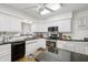 Well-lit kitchen equipped with stainless steel appliances, white cabinets, and dark countertops at 2731 N 23Rd Ave, Phoenix, AZ 85009