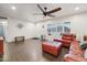 Inviting living room showcasing a brick-toned leather sectional sofa, ceiling fan, and tiled flooring at 2731 N 23Rd Ave, Phoenix, AZ 85009