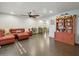 Open-concept living room featuring a red leather sectional sofa and tiled flooring at 2731 N 23Rd Ave, Phoenix, AZ 85009