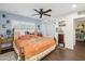 Bright main bedroom with a cozy quilt, shuttered windows, and wood-style tiled floor at 2731 N 23Rd Ave, Phoenix, AZ 85009
