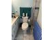 Compact bathroom with functional layout, including toilet, towel rack, and shower stall at 2840 W Marlette Ave, Phoenix, AZ 85017
