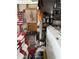 Garage interior with laundry area, stacked shelves, and disorganized items at 2840 W Marlette Ave, Phoenix, AZ 85017