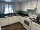 Well-lit kitchen with white cabinets, stainless steel sink, and modern appliances at 2840 W Marlette Ave, Phoenix, AZ 85017