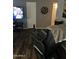 Cozy living room featuring a black massage chair and wood-look flooring at 2840 W Marlette Ave, Phoenix, AZ 85017