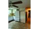 Functional kitchen features tile flooring, white cabinets, and modern refrigerator at 3104 E Broadway Rd # 295, Mesa, AZ 85204