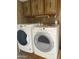 Bright laundry room featuring a washer and dryer with cabinet space at 3104 E Broadway Rd # 295, Mesa, AZ 85204