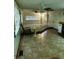 Bright and inviting living room features tile flooring, ceiling fan and large windows at 3104 E Broadway Rd # 295, Mesa, AZ 85204