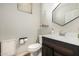 Comfortable half bath includes decorative shelving and a stylish dark wood vanity at 3190 S Holguin Way, Chandler, AZ 85248