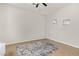 Bedroom with neutral walls, tiled floors, ceiling fan and a gray patterned area rug at 3190 S Holguin Way, Chandler, AZ 85248