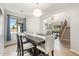 Bright dining room with large table and seating, open to living spaces and staircase with natural light at 3190 S Holguin Way, Chandler, AZ 85248