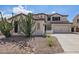 Two-story home featuring a neutral paint scheme, a three car garage, and desert landscaping at 3190 S Holguin Way, Chandler, AZ 85248