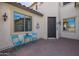 Cozy front porch area with blue chairs, brick floor, and a cute welcome mat at 3190 S Holguin Way, Chandler, AZ 85248
