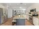 Modern kitchen with granite countertops, stainless steel appliances, and seamless flow to living areas at 3190 S Holguin Way, Chandler, AZ 85248