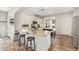 Well-lit kitchen featuring a breakfast bar, stainless steel appliances, and ample cabinet space at 3190 S Holguin Way, Chandler, AZ 85248