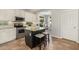 Charming kitchen with island, stainless appliances, and barstool seating, adjacent to the dining area at 3190 S Holguin Way, Chandler, AZ 85248