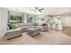 Open-concept living room with sectional sofa, breakfast bar and stools, flooded with natural light at 3190 S Holguin Way, Chandler, AZ 85248