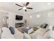 Comfortable living room with a large sectional, ceiling fan, and TV, perfect for relaxing and entertaining at 3190 S Holguin Way, Chandler, AZ 85248