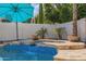 Beautiful pool and spa detail with a baja step surrounded by travertine at 3190 S Holguin Way, Chandler, AZ 85248