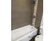 Bathroom featuring tiled walls, stylish shower head, and sleek bathtub at 327 E La Jolla Dr, Tempe, AZ 85282