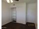 This bedroom features a ceiling fan and a closet with sliding doors at 327 E La Jolla Dr, Tempe, AZ 85282