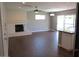 Spacious living room features a white brick fireplace, hardwood floors, and sliding glass doors to the backyard at 327 E La Jolla Dr, Tempe, AZ 85282