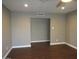 Open living room with dark hardwood floors, neutral paint, and an open doorway to another room at 327 E La Jolla Dr, Tempe, AZ 85282