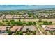 Expansive aerial view of a community showcasing well-maintained homes, green spaces, and mountain views at 3400 S Whetstone Pl, Chandler, AZ 85286